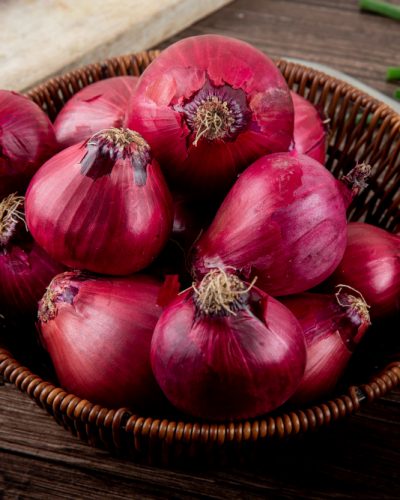 side-view-basket-full-red-onions-wooden-background